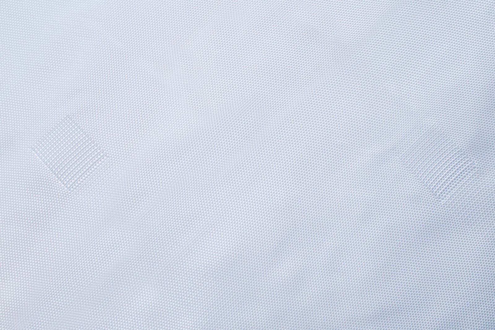 Close-up view of a textured concrete mattress fabric, showcasing a woven pattern that provides strength and durability. The fabric appears lightweight yet robust, ideal for erosion control and landscape stabilization in civil engineering projects.